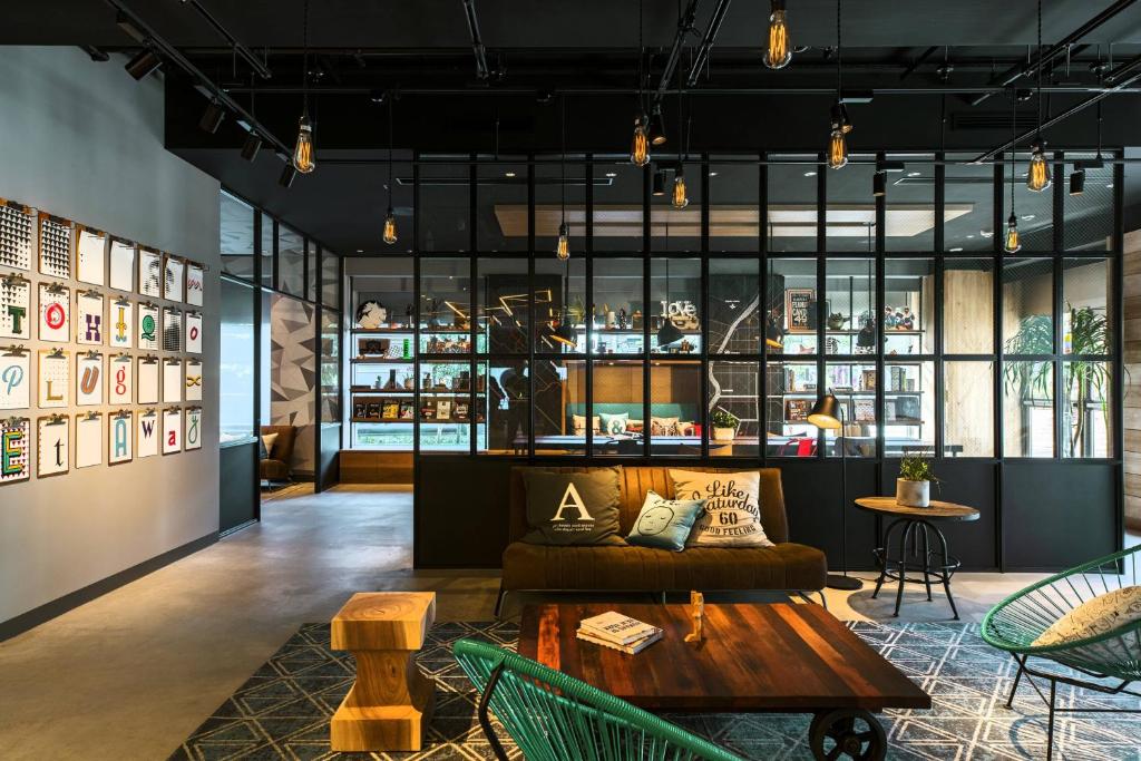 a living room with a couch and a table at MOXY Tokyo Kinshicho in Tokyo