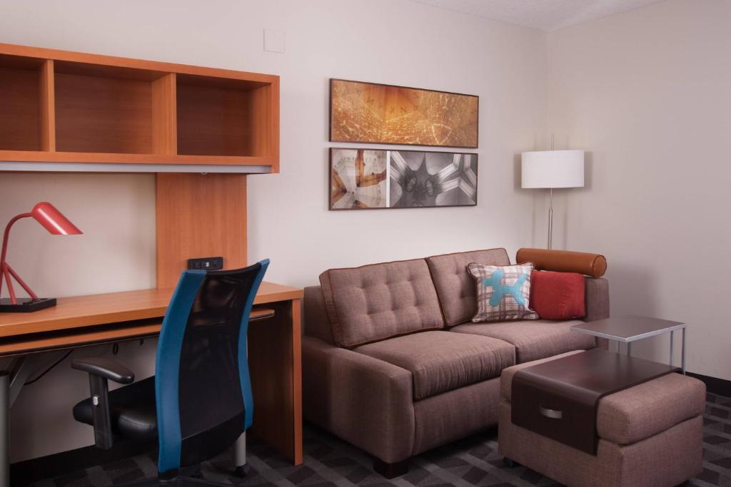a living room with a couch and a desk at TownePlace Suites The Villages in The Villages
