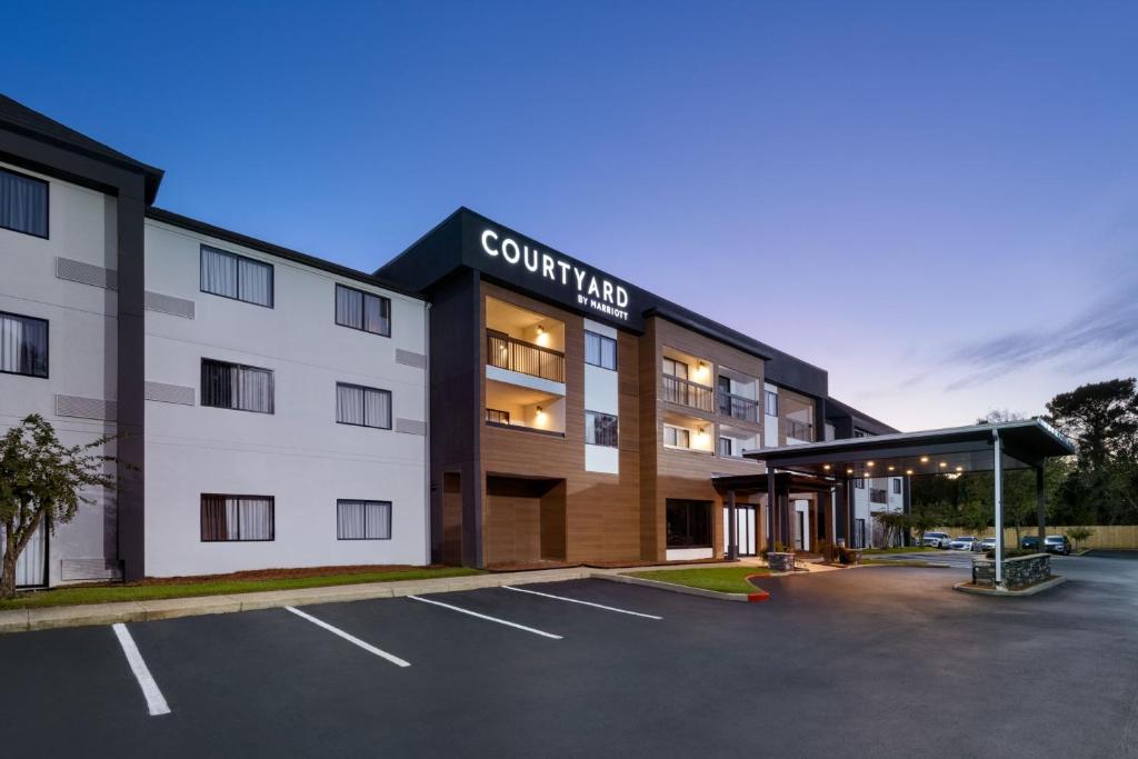 a building with a parking lot in front of it at Courtyard Mobile in Mobile