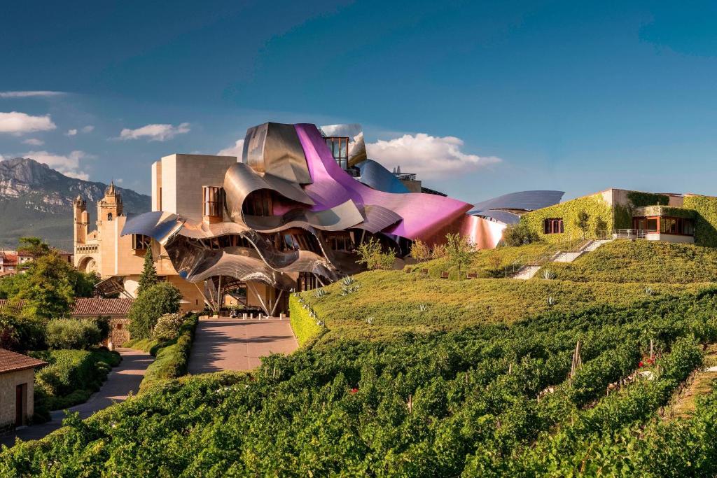 a building sitting on top of a hill at Hotel Marqués de Riscal, a Luxury Collection Hotel, Elciego in Elciego