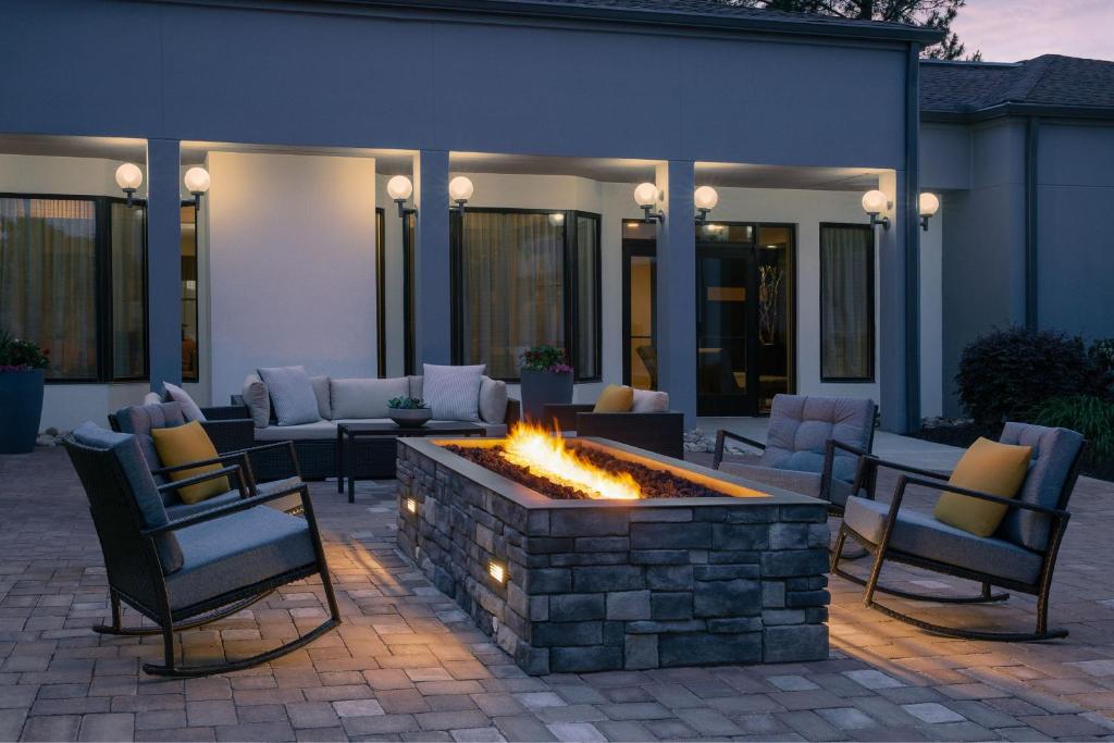 a patio with chairs and a fire pit at Courtyard by Marriott Greensboro in Greensboro