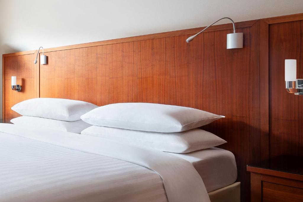 a bedroom with a bed with white pillows on it at Riviera Marriott Hotel La Porte De Monaco in Cap d'Ail