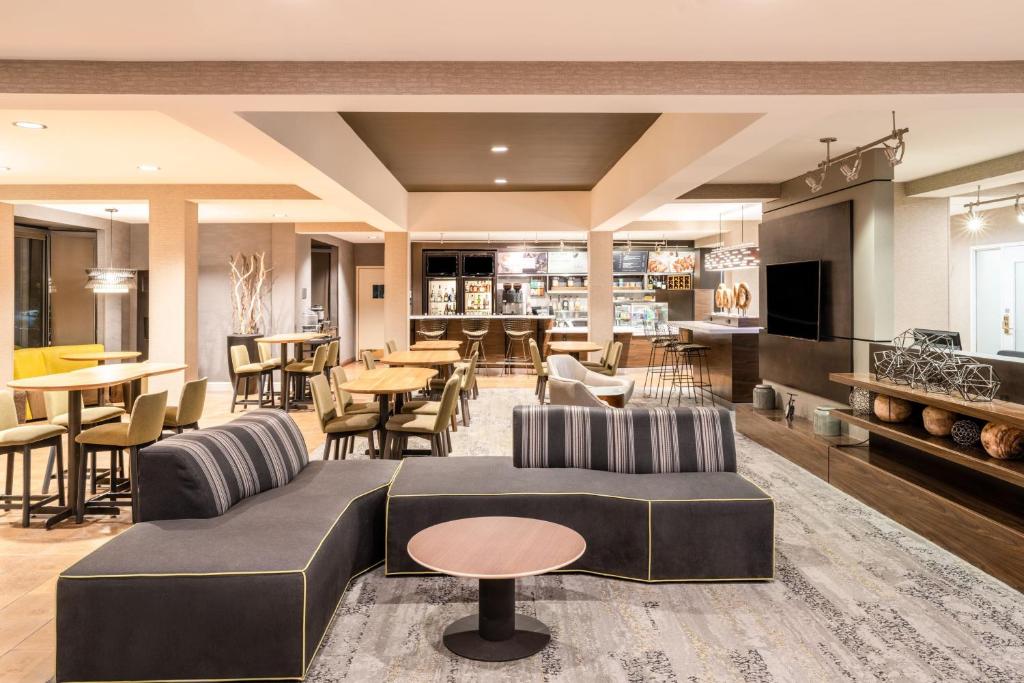 a living room with a couch and chairs and tables at Courtyard by Marriott Colorado Springs South in Colorado Springs