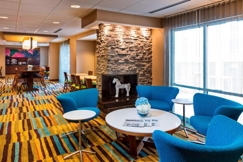 a waiting room with chairs and a fireplace at Fairfield Inn & Suites by Marriott Atlanta Buckhead in Atlanta
