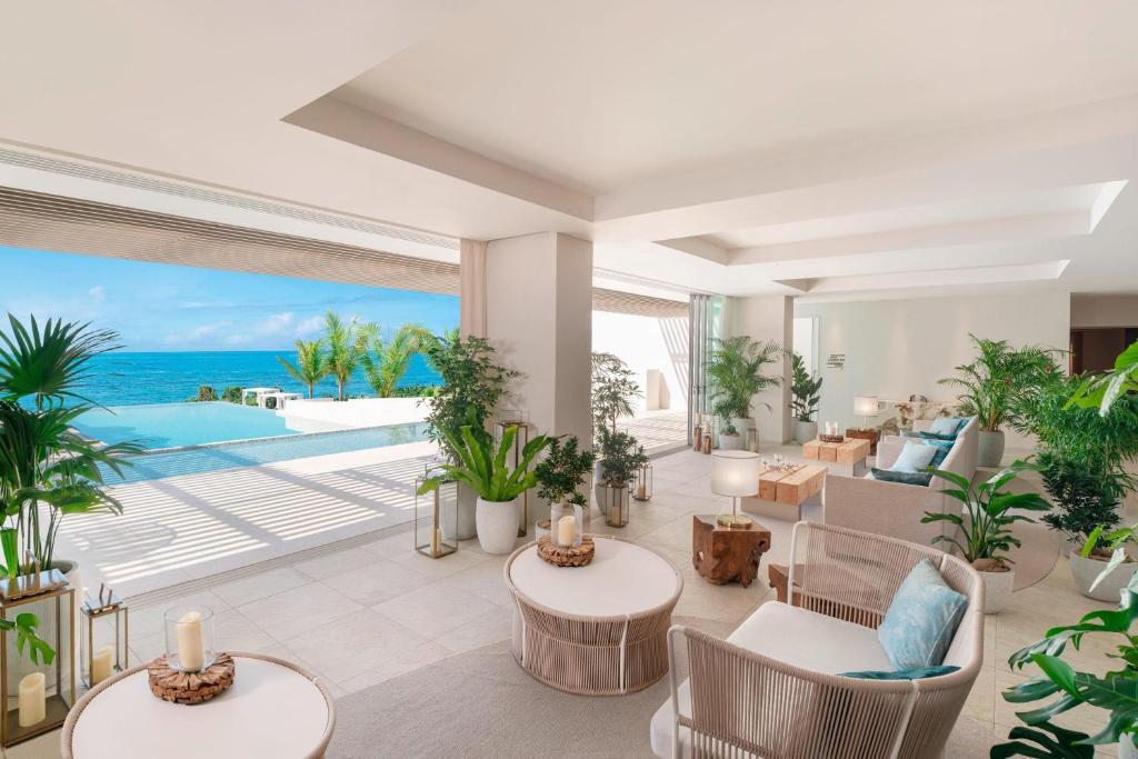 a living room with a view of the ocean at IRAPH SUI, a Luxury Collection Hotel, Miyako Okinawa in Miyako Island