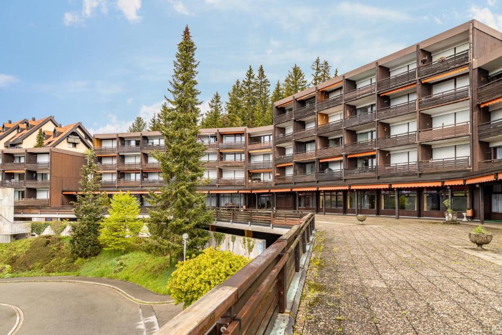 an apartment building with a walkway in front of it at Terrassenpark Schonach App 161 in Schonach