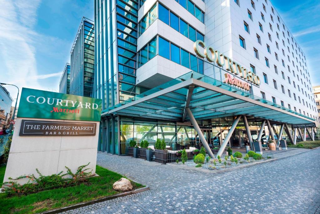 a building with a sign in front of it at Courtyard by Marriott Prague City in Prague