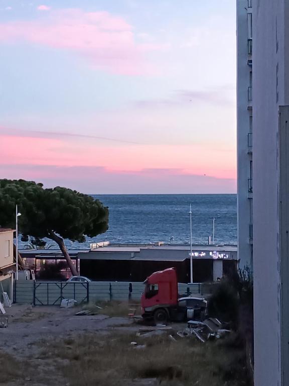 un camion rouge garé dans un parking à côté de l'océan dans l'établissement Juan-Les-Pins centre, à Antibes
