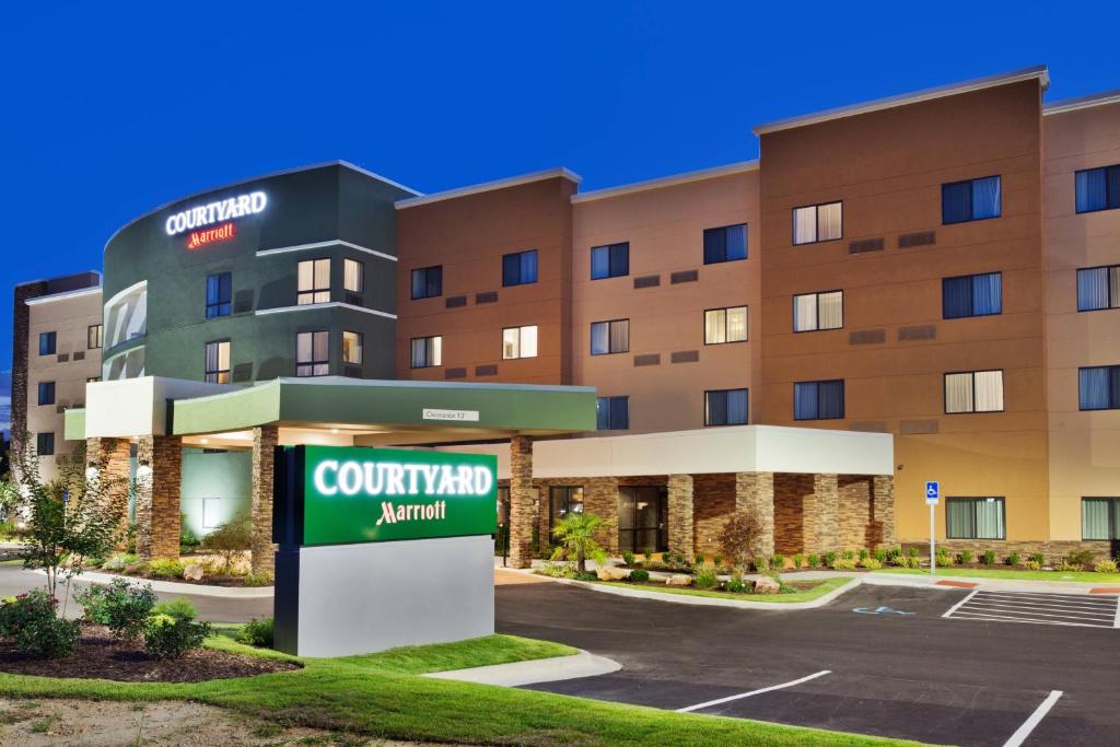 a rendering of the front of a hotel with acourt yardanu sign at Courtyard by Marriott Auburn in Auburn