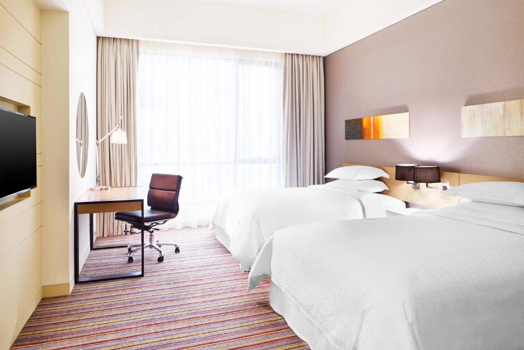 Postel nebo postele na pokoji v ubytování Four Points by Sheraton Puchong
