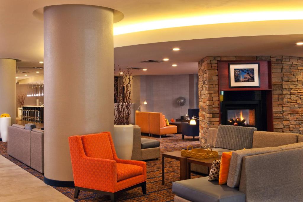 a lobby with couches and chairs and a fireplace at Courtyard by Marriott Alexandria Pentagon South in Alexandria