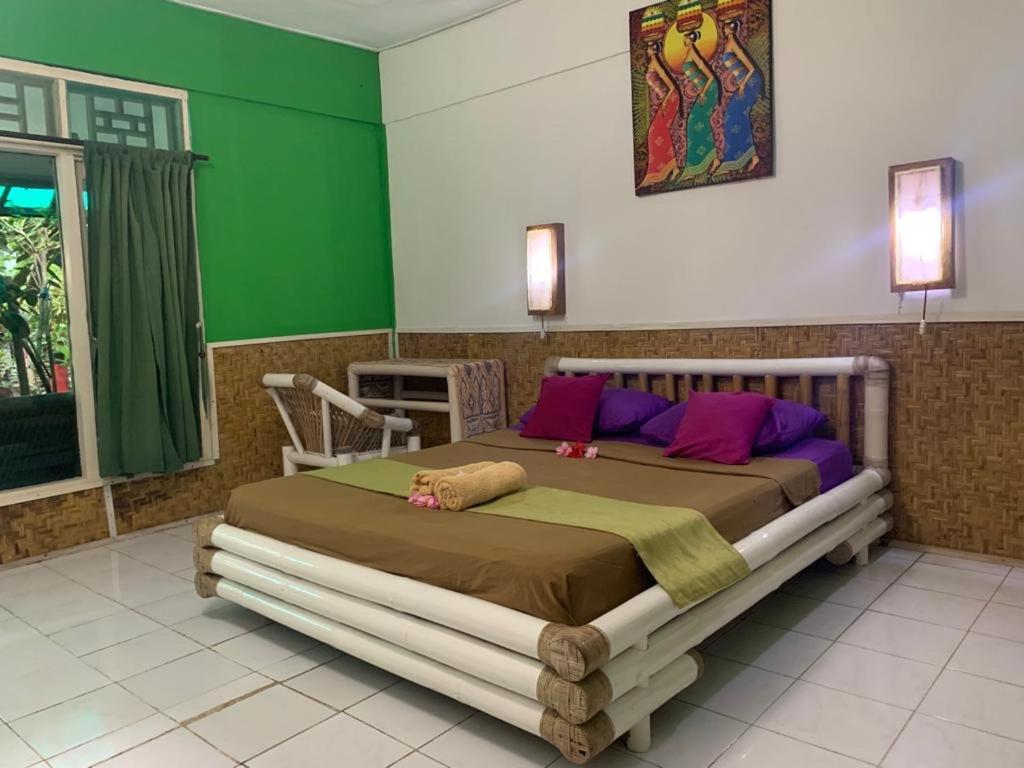 Postel nebo postele na pokoji v ubytování Rumah Kundun