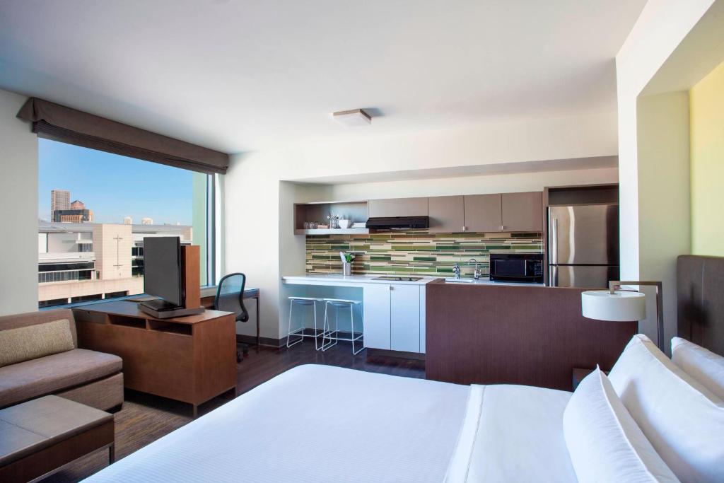 a hotel room with a kitchen and a bed and a couch at Element Boston Seaport District in Boston