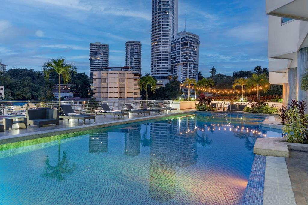 a swimming pool with a city skyline in the background at Marriott Executive Apartments Panama City, Finisterre in Panama City