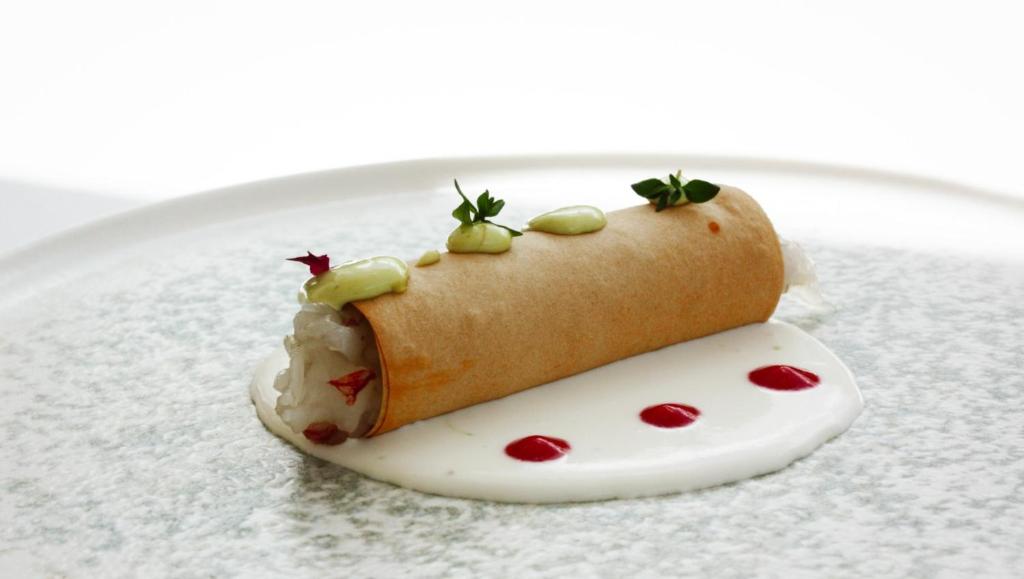 a dessert on a plate with a hot dog on top at Principe Alogna Hotel & SPA in Altavilla Milicia