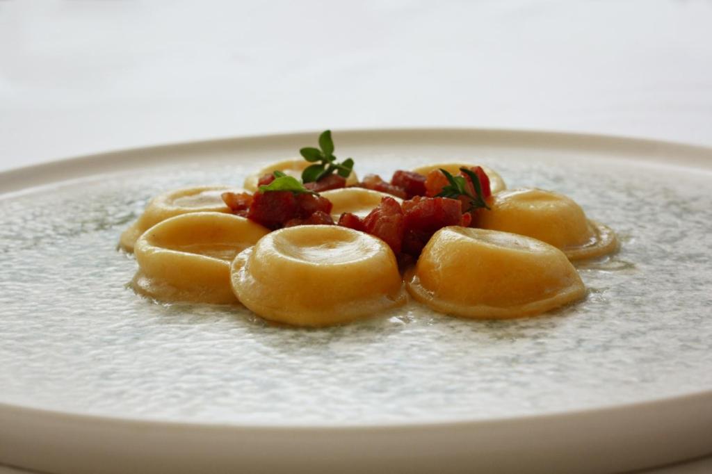 a plate of food with ravioli on it at Principe Alogna Hotel & SPA in Altavilla Milicia