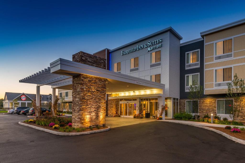 a hotel with a parking lot in front of it at Fairfield Inn & Suites by Marriott Plymouth White Mountains in Plymouth