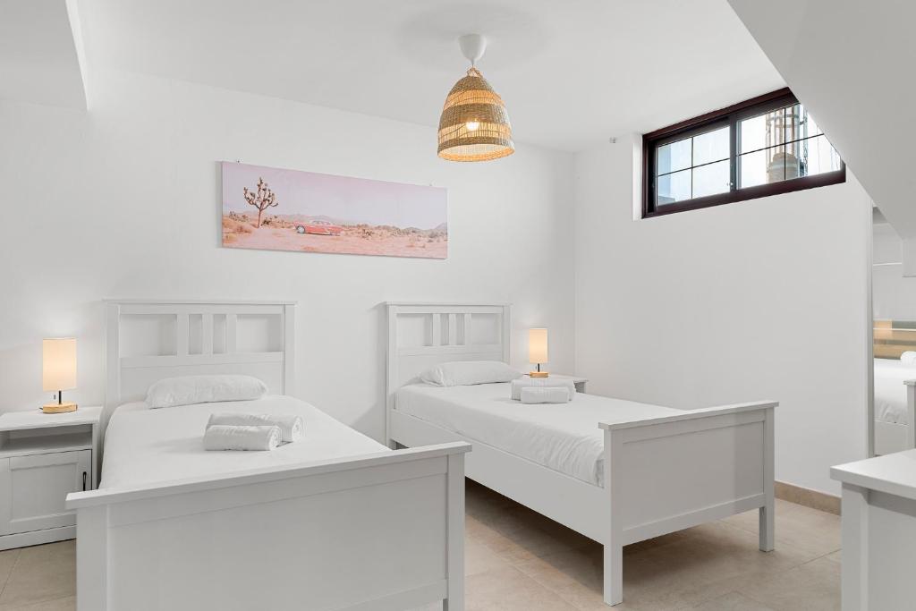 Posteľ alebo postele v izbe v ubytovaní MEDANO4YOU The Palm Tree Holiday Home