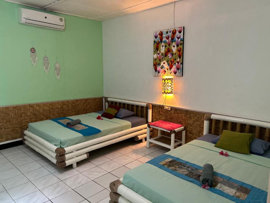 Postel nebo postele na pokoji v ubytování Rumah Kundun