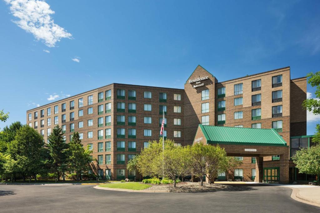 a building with a parking lot in front of it at Residence Inn by Marriott Minneapolis Edina in Edina