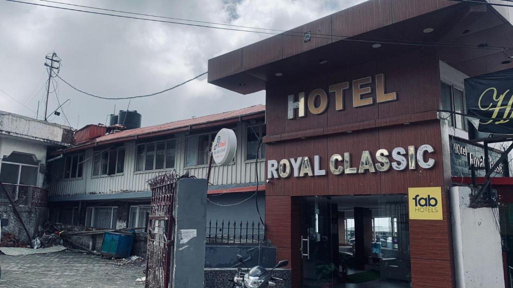 a hotel with a sign on the side of a building at Hotel Royal Classic @ Mall Road Mussoorie in Mussoorie