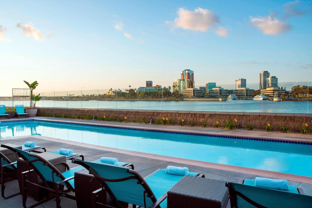 a swimming pool with chairs and a view of the city at Residence Inn Long Beach Downtown in Long Beach