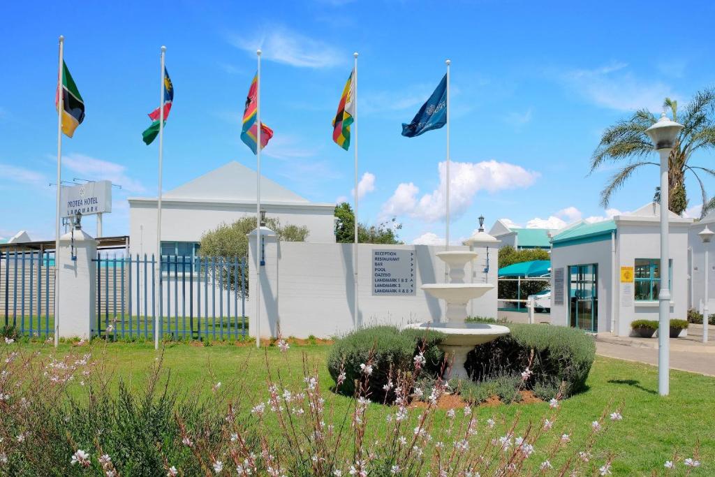 a group of flags in front of a building at Protea Hotel by Marriott Polokwane Landmark in Polokwane