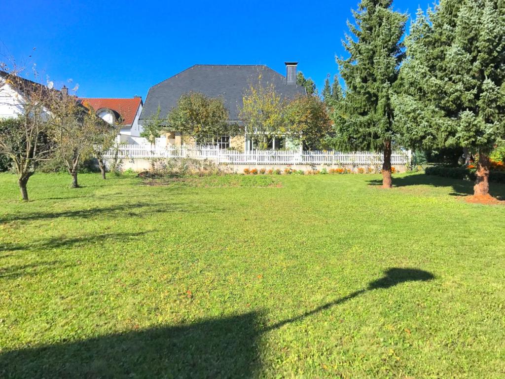 a shadow on the grass in a yard with a fence at VILLA ORCHARD Frankfurt in Zeilsheim
