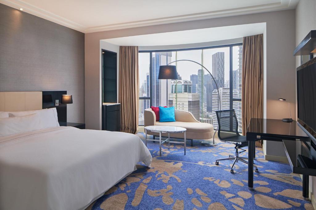 a hotel room with a bed and a desk at The Westin Kuala Lumpur in Kuala Lumpur