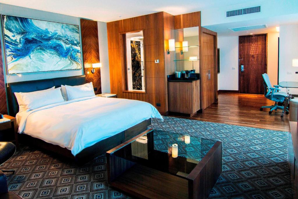 a hotel room with a large bed and a desk at JW Marriott Hotel Santo Domingo in Santo Domingo