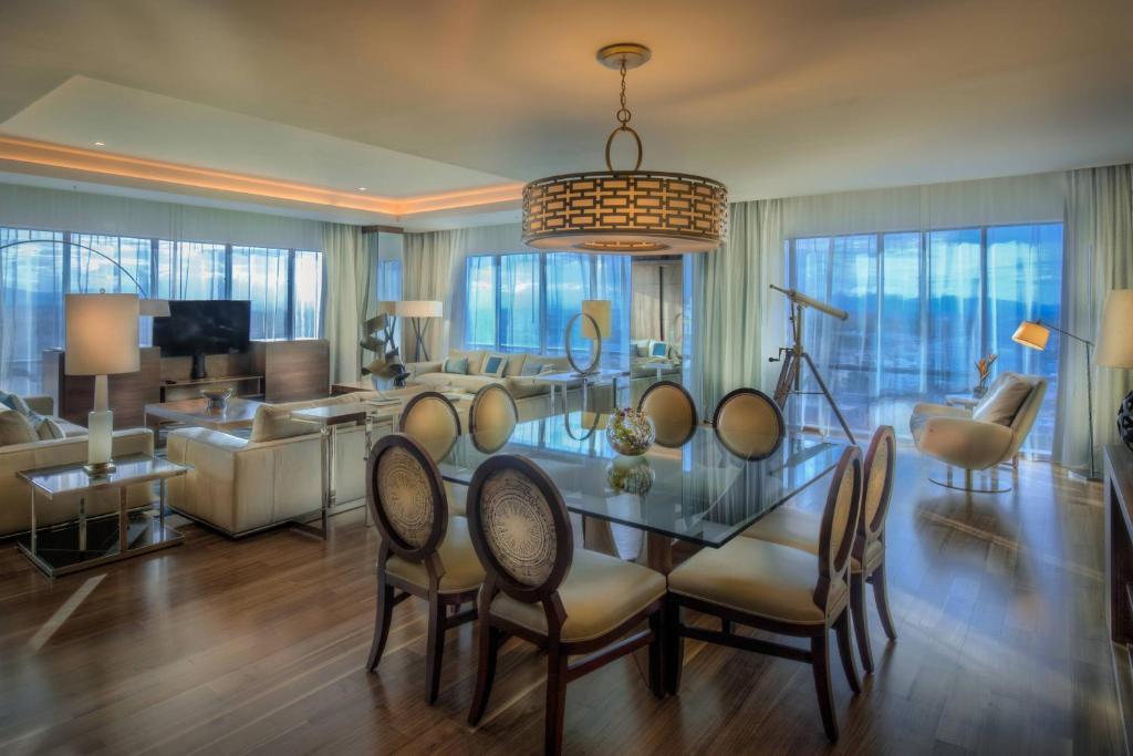 a living room with a glass table and chairs at JW Marriott Hotel Santo Domingo in Santo Domingo