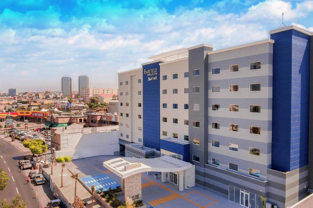 an aerial view of a building with a city in the background at Fairfield Inn & Suites by Marriott Tijuana in Tijuana