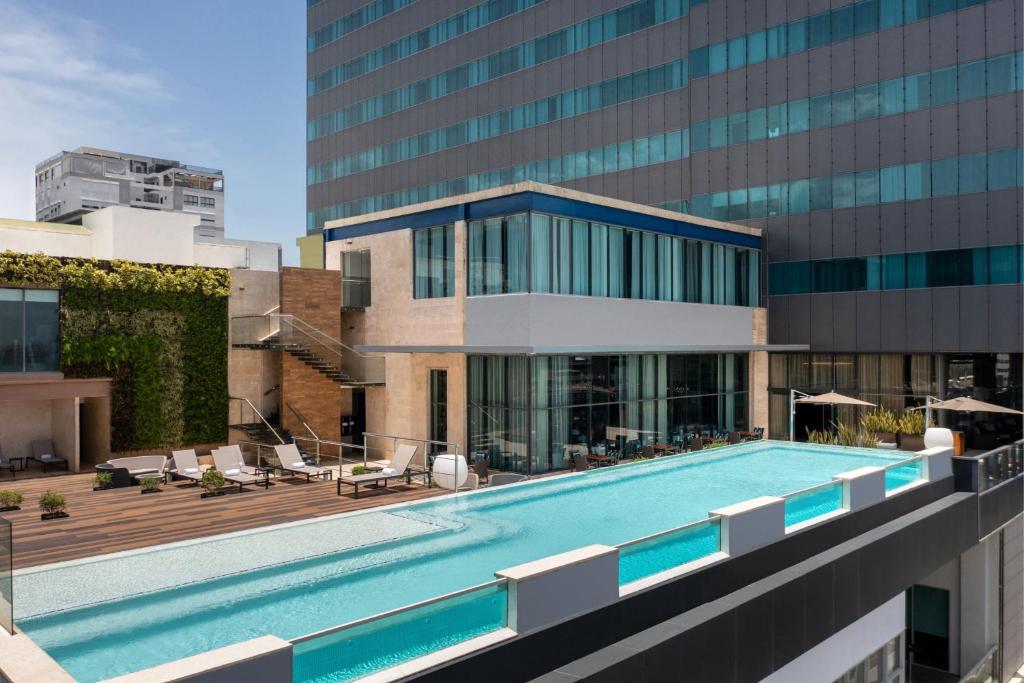 a swimming pool in front of a building at JW Marriott Hotel Santo Domingo in Santo Domingo