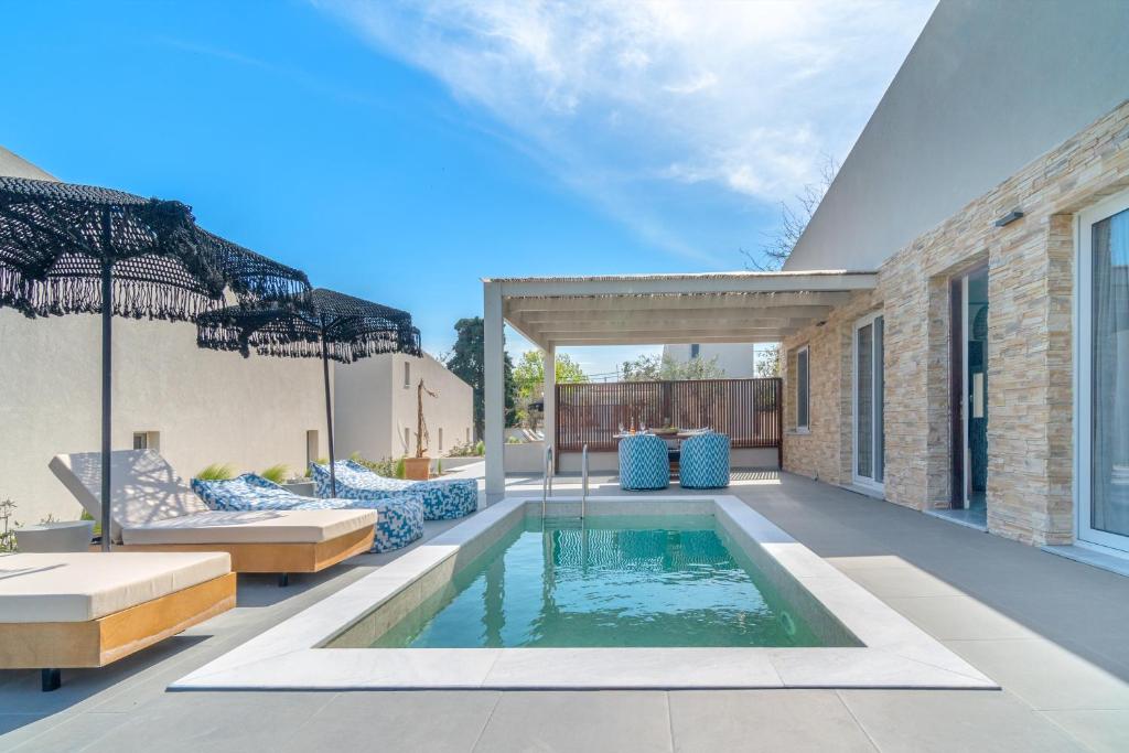 a swimming pool in the backyard of a house at Utopia Eco Retreat in Skiathos Town