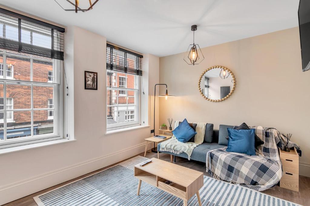 a living room with a couch and a table at Nadler Studios in Norwich