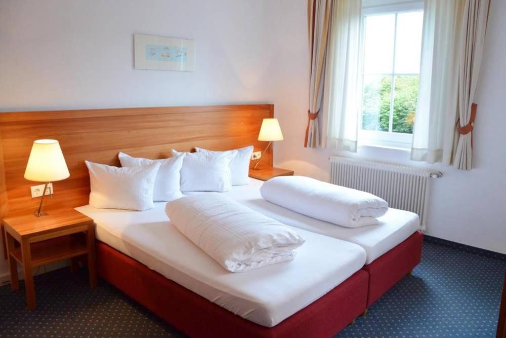 Postel nebo postele na pokoji v ubytování Seehotel Schlick