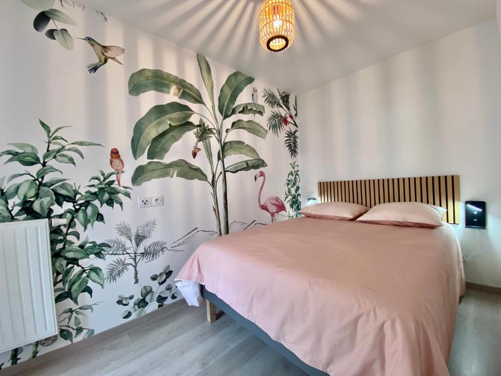 a bedroom with a bed with a large plant mural at Appartement T2 cosy centre ville in Thonon-les-Bains