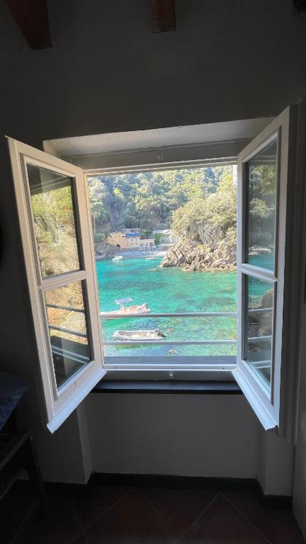a window with a view of a body of water at Casa dell'Arco Civico 35 in San Fruttuoso