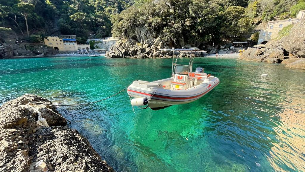 a boat in the water on a river at Casa dell'Arco Civico 35 in San Fruttuoso