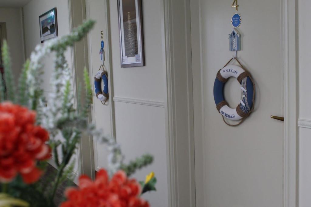 a room with a door with a wreath and flowers at Bridport Arms Hotel in West Bay