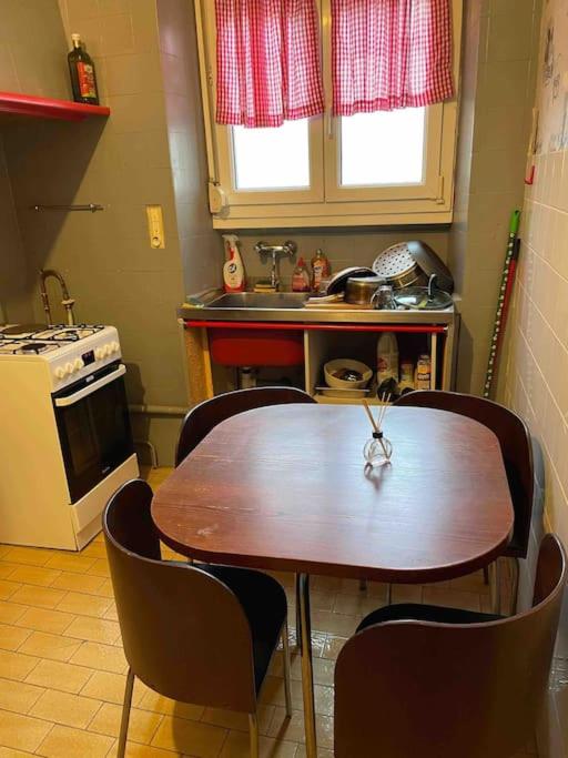 a kitchen with a wooden table and chairs in it at Chez dada in Grenoble