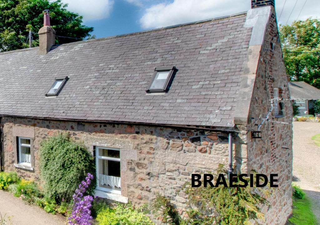 an old stone house with the words brashside written on it at Braeside in Wooler