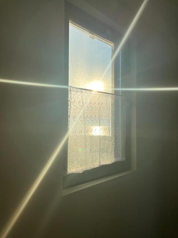a window in a bathroom with a curtain at Apartments Linic in Nin
