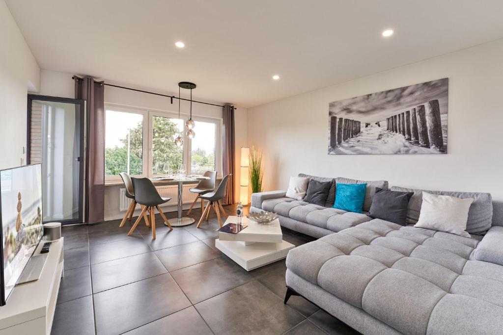 a living room with a couch and a table at Haus Deepensoll 39 Ankerplatz in Pelzerhaken