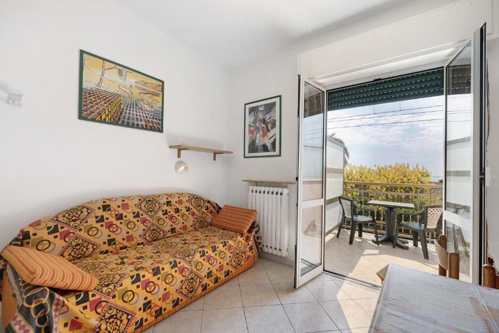 a living room with a couch and a balcony at Numero 14 in Borgio Verezzi