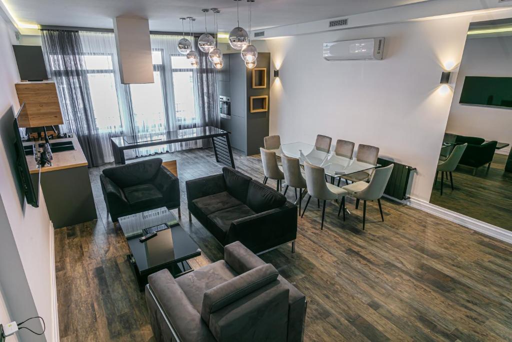 a living room with a couch and a table and chairs at Luxe Apartment in Center in Yerevan