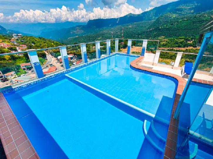 a large swimming pool on top of a building at Apartamentos vacacionales San Gil Plaza in San Gil