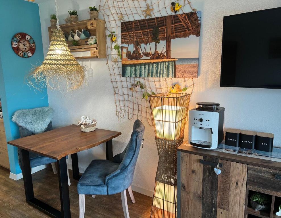a dining room with a table and a television at Seeblick Betty in Gaienhofen