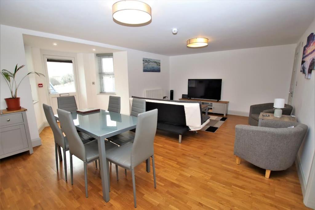 a living room with a dining room table and chairs at St James Apartment in Ilfracombe