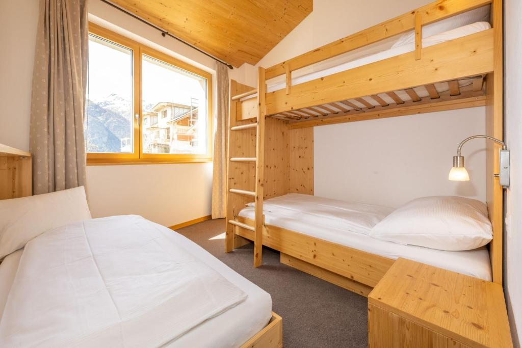 Postel nebo postele na pokoji v ubytování Aktiv Hotel & Spa Hannigalp